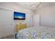 Bedroom with mounted TV and yellow dresser at 112 Mangrove Ave, Anna Maria, FL 34216