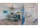 Bright dining room with table and ocean-themed art at 112 Mangrove Ave, Anna Maria, FL 34216