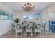 Bright dining room features a large table with seating for eight and stylish light fixture at 112 Mangrove Ave, Anna Maria, FL 34216