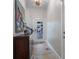 Bright entryway with mosaic floor, sea turtle art, and a unique chandelier at 112 Mangrove Ave, Anna Maria, FL 34216