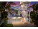 Three-story house with pastel exterior, a two-car garage, and palm trees at 112 Mangrove Ave, Anna Maria, FL 34216