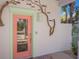 Unique front door with artistic accents and beachy style at 112 Mangrove Ave, Anna Maria, FL 34216
