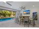 Game room with bar, TV, and view of the pool at 112 Mangrove Ave, Anna Maria, FL 34216