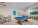 Game room with pool table and comfortable seating at 112 Mangrove Ave, Anna Maria, FL 34216