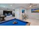 Game room with pool table, shuffleboard, and access to a private pool at 112 Mangrove Ave, Anna Maria, FL 34216