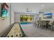 Game room with shuffleboard, bar, and pool view at 112 Mangrove Ave, Anna Maria, FL 34216