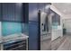 Modern kitchen with stainless steel refrigerator and blue cabinets at 112 Mangrove Ave, Anna Maria, FL 34216