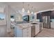 Open concept kitchen with large island and stainless steel appliances at 112 Mangrove Ave, Anna Maria, FL 34216
