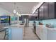 Modern kitchen with marble island, stainless steel appliances, and teal backsplash at 112 Mangrove Ave, Anna Maria, FL 34216