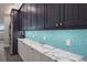 Kitchen boasts marble countertops and teal backsplash at 112 Mangrove Ave, Anna Maria, FL 34216