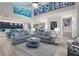 Spacious living room with vaulted ceilings, hardwood floors, and coastal decor at 112 Mangrove Ave, Anna Maria, FL 34216