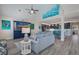 Living room with open floor plan, navy blue cabinet and comfortable seating at 112 Mangrove Ave, Anna Maria, FL 34216