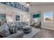 Spacious living room boasts a comfortable sofa and armchairs, and high ceilings at 112 Mangrove Ave, Anna Maria, FL 34216
