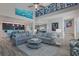 Open concept living room with high ceilings and view into kitchen at 112 Mangrove Ave, Anna Maria, FL 34216