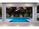 View of a rectangular pool from covered patio at 112 Mangrove Ave, Anna Maria, FL 34216