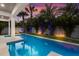 Luxury pool with patio and landscaping at sunset at 112 Mangrove Ave, Anna Maria, FL 34216