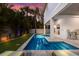 L-shaped pool with patio, lounge chairs, and landscaping at 112 Mangrove Ave, Anna Maria, FL 34216