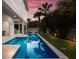 Long rectangular pool with surrounding patio and lawn at 112 Mangrove Ave, Anna Maria, FL 34216