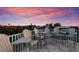 Enjoy breathtaking sunset views from this rooftop deck with multiple seats at 112 Mangrove Ave, Anna Maria, FL 34216