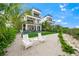 Private backyard oasis with white chairs and tropical landscaping at 116 8Th Street S, Bradenton Beach, FL 34217