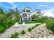 Modern coastal home with a spacious backyard and stone retaining wall at 116 8Th Street S, Bradenton Beach, FL 34217