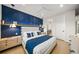 Stylish bedroom with a blue accent wall and comfortable bedding at 116 8Th Street S, Bradenton Beach, FL 34217