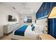 Bedroom with blue accent wall and modern furnishings at 116 8Th Street S, Bradenton Beach, FL 34217
