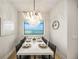 Elegant dining room with large window and modern chandelier at 116 8Th Street S, Bradenton Beach, FL 34217