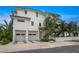 White three-story home with two-car garage and palm trees at 116 8Th Street S, Bradenton Beach, FL 34217