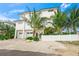 White three-story home with attached two-car garage at 116 8Th Street S, Bradenton Beach, FL 34217