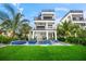 Modern three-story home with a private pool and lush landscaping at 116 8Th Street S, Bradenton Beach, FL 34217