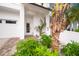 Landscaped front yard with tropical plants at 116 8Th Street S, Bradenton Beach, FL 34217