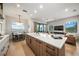 Modern kitchen with island, quartz countertops, and stainless steel appliances at 116 8Th Street S, Bradenton Beach, FL 34217