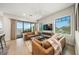 Spacious living room with water views, featuring comfortable sofas and large windows at 116 8Th Street S, Bradenton Beach, FL 34217