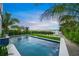 Modern rectangular pool with waterfall and water views at 116 8Th Street S, Bradenton Beach, FL 34217