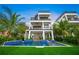 Three-story home with a beautiful pool and lush landscaping at 116 8Th Street S, Bradenton Beach, FL 34217