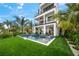Luxury home with private pool, expansive patio, and lush landscaping at 116 8Th Street S, Bradenton Beach, FL 34217