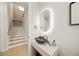 Stylish powder room with a unique sink and illuminated mirror at 116 8Th Street S, Bradenton Beach, FL 34217