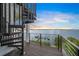 Modern spiral staircase leading to a waterfront deck at 116 8Th Street S, Bradenton Beach, FL 34217