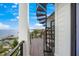 Modern spiral staircase leading to a waterfront deck at 116 8Th Street S, Bradenton Beach, FL 34217