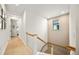 Light-filled upstairs hallway with modern wood flooring and railing at 116 8Th Street S, Bradenton Beach, FL 34217
