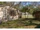 Back of house with a yard and trees at 1205 Willis Ave, Sarasota, FL 34232