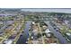 Aerial view showcasing the property's waterfront location in a quiet neighborhood at 128 Sinclair Se St, Port Charlotte, FL 33952