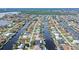Aerial view of canal-front home with private dock and lush landscaping at 128 Sinclair Se St, Port Charlotte, FL 33952