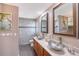 Bathroom with double sinks, large mirrors, and shower at 128 Sinclair Se St, Port Charlotte, FL 33952
