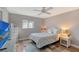 Serene bedroom featuring a queen bed, TV and wicker furniture at 128 Sinclair Se St, Port Charlotte, FL 33952