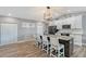 Modern kitchen with granite island, stainless steel appliances, and white cabinets at 128 Sinclair Se St, Port Charlotte, FL 33952