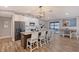 Modern kitchen with granite island, stainless steel appliances, and white cabinets at 128 Sinclair Se St, Port Charlotte, FL 33952