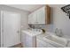 Functional laundry room with washer, dryer and storage at 128 Sinclair Se St, Port Charlotte, FL 33952