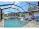 Inviting pool area with covered patio and spa at 128 Sinclair Se St, Port Charlotte, FL 33952